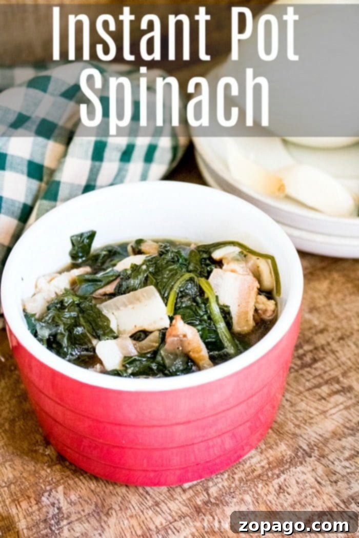 A large serving of Instant Pot spinach, steaming hot and ready to be served, scooped from the pressure cooker, showcasing its vibrant color and tender texture.