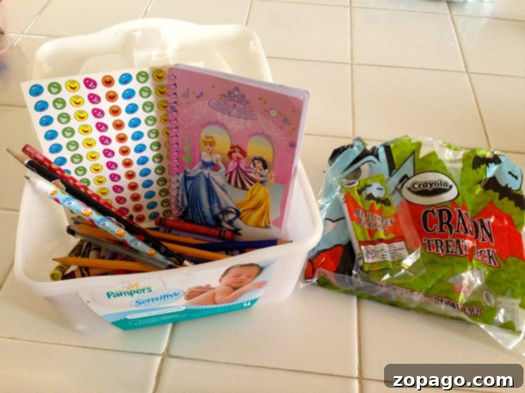 Engaging Kids During Restaurant Meals 5 An open baby wipe container repurposed as a busy box, filled with crayons and a small notepad, ideal for keeping kids busy.