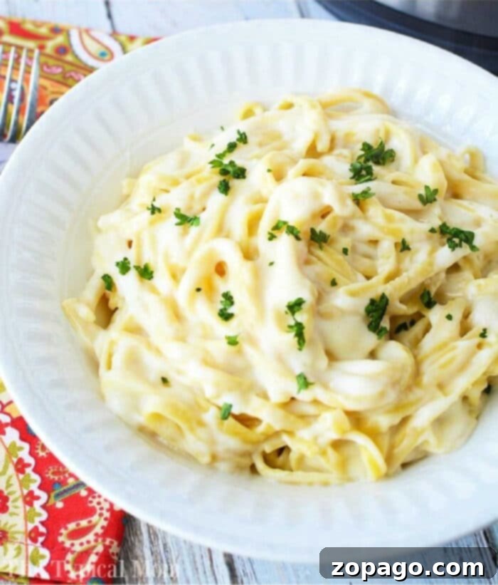 Creamy Instant Pot Fettuccine Alfredo 2 Instant Pot Fettuccine Alfredo served in a bowl, garnished with fresh parsley.