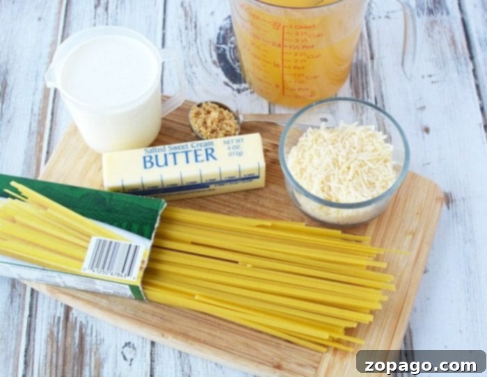 This Instant Pot fettuccine alfredo recipe is easy to make and a creamy buttery dinner your whole family is sure to love. Inexpensive pressure cooker meal. #instantpot #instantpotrecipes #alfredo #fettuccinealfredo #pasta #easy A wooden cutting board with ingredients for Instant Pot fettuccine Alfredo: uncooked spaghetti, a stick of butter, grated Parmesan cheese, a measuring cup with liquid, a cup of cream, and a clove of garlic.
