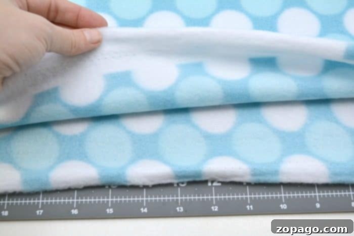 DIY Knot Pillow Supplies: Fleece, Scissors, Ruler, Pillow Form, Marker Measuring and marking fleece fabric with a ruler and marker, a crucial step in the no-sew knot pillow tutorial.