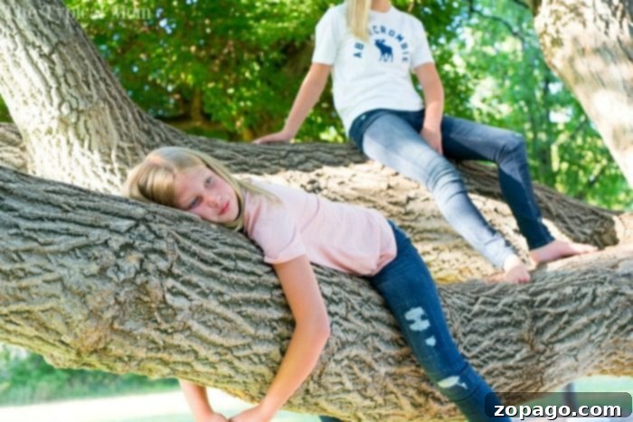 Active girl playing outdoors in durable Abercrombie Kids jeans, showing flexibility.