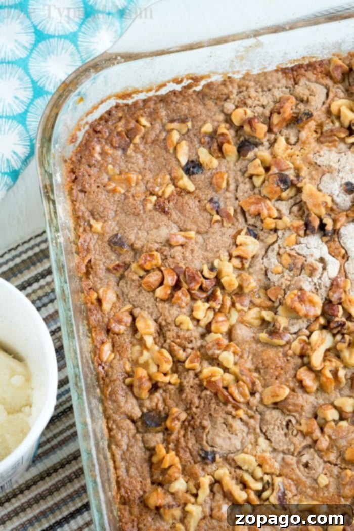 If you're ready for Fall flavors you've got to try this easy pumpkin pie dump cake that needs just 5 basic ingredients! Topped with ice cream it's heaven! #pumpkin #pumpkinpie #dessert #dumpcake #cake #fall Easy pumpkin cake recipe, a delicious and moist dessert made with minimal ingredients, served warm with ice cream.