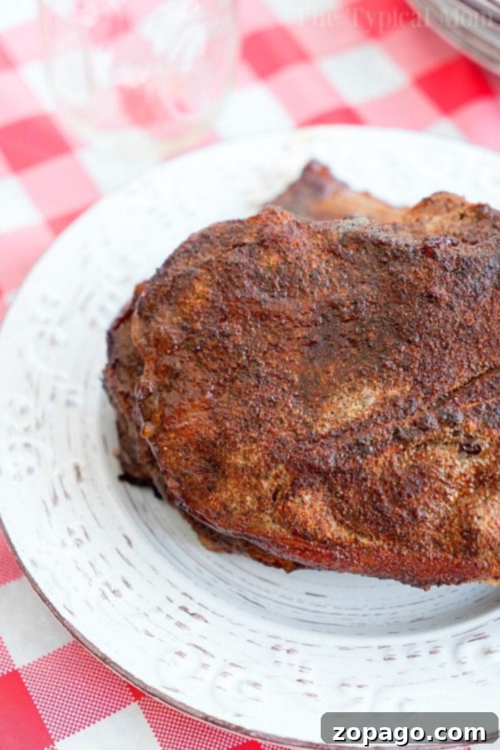 Smoked pork steaks with an amazing dry rub make a great dinner! Full of flavor and easy to make. #smoked #smoker #pork #steaks #dryrub #smokerrecipes #smokedpork A close-up shot of a perfectly cooked smoked pork steak, showing its rich, caramelized crust and juicy interior.