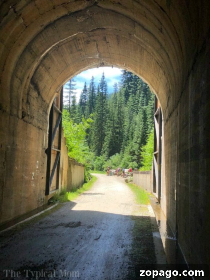 Views of the Hiawatha bike trail are here from a family who travels together a lot! North of Couer d'Alene this is an epic bike ride you have got to take. #hiawatha #bike #trail #route #pictures #video #idaho #best #couerdalene #north Cyclists Exiting the Taft Tunnel on Hiawatha Trail