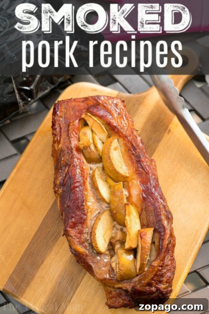 Amazing apple stuffed smoked pork loin recipe that takes just 15 minutes to prep! With our dry rub and fruit, you'll have tender pork you'll love. #smoked #pork #easy #dryrub #apple #best #electricsmoker #smokerrecipes #smokedpork A beautifully smoked apple stuffed pork loin, perfectly sliced to reveal its tender interior and sweet apple filling, resting on a rustic cutting board. This image highlights the delicious results of our easy smoked pork recipes, ready to be enjoyed.