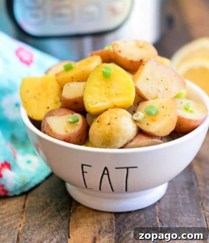 Perfectly Tender Instant Pot Baby Potatoes 2 A bowl of seasoned instant pot baby potatoes garnished with green onion slices sits enticingly in a dish labeled eat on a rustic wooden table.