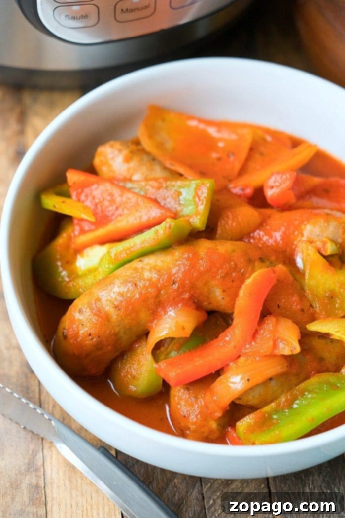 Savory Sausage Dishes 3 A close-up of a delicious Instant Pot sausage and peppers dish, featuring tender sausage links, colorful bell peppers, and onions, all perfectly cooked and ready to serve.