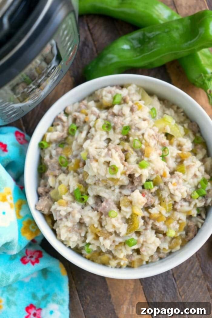 Instant Pot sausage recipes for you to enjoy with ground sausage as well as sausage links mild or spicy. Breakfast and dinner are covered. #instantpot #pressurecooker #sausage #instantpotrecipes #groundsausage #dinner #breakfast #sausagelinks A bowl of creamy rice dish with ground sausage, chopped green peppers, and garnished with green onions. Two whole green peppers and a colorful patterned cloth are beside the bowl on a wooden surface. An Instant Pot recipe comes to life in the top left corner.