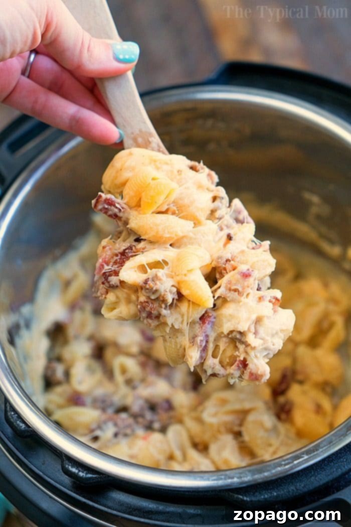 Speedy Meat Lovers Mac and Cheese 7 Large serving of Meat Lover Pressure Cooker Mac and Cheese in a bowl, showing the generous amount of meat and creamy sauce.