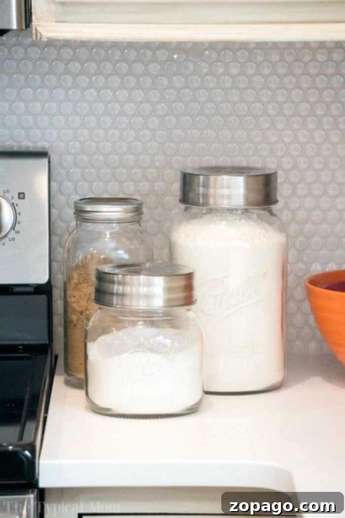 Versatile Mason Jar Decor for Your Farmhouse Kitchen Large mason jars used for storage in a farmhouse kitchen