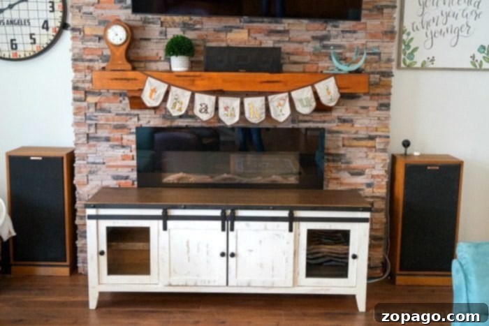 Our farmhouse TV stand blends seamlessly with the new shiplap accent wall. Modern farmhouse living room with white shiplap wall and TV stand
