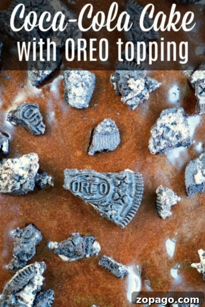 This rich Coca Cola chocolate cake with OREO topping is delicious and easy to make with your kids! Perfect dessert when people come over or for a potluck. #cocacola #coke #cola #cake #chocolate #oreo Slice of Coke Cake Recipe