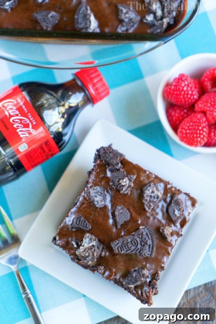 Decadent Coca-Cola Chocolate Cake 7 A large Coca-Cola Chocolate Cake with a thick layer of chocolate frosting and crushed Oreos.