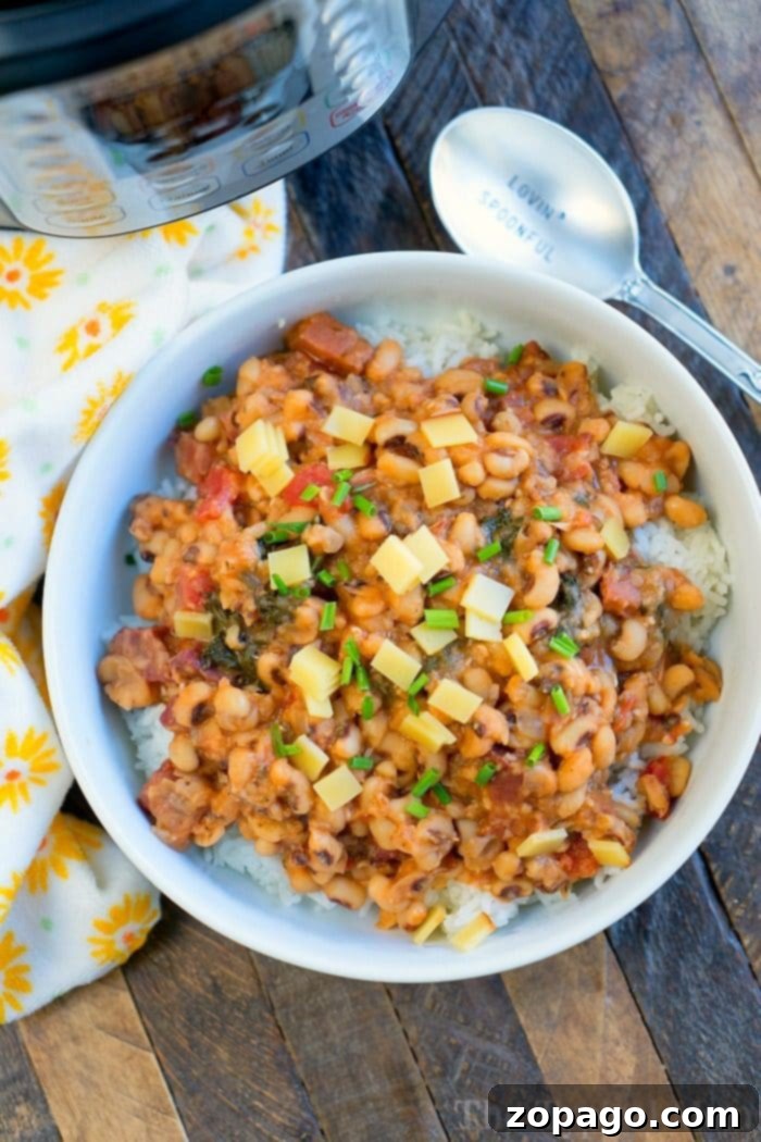 Best Instant Pot Hoppin' John Recipe with Ham and Dried Black-Eyed Peas Instant Pot Hoppin' John with tender black-eyed peas and savory ham, a traditional New Year's dish, garnished with fresh herbs.