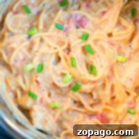 Instant Pot chicken spaghetti in a white bowl, ready to eat.