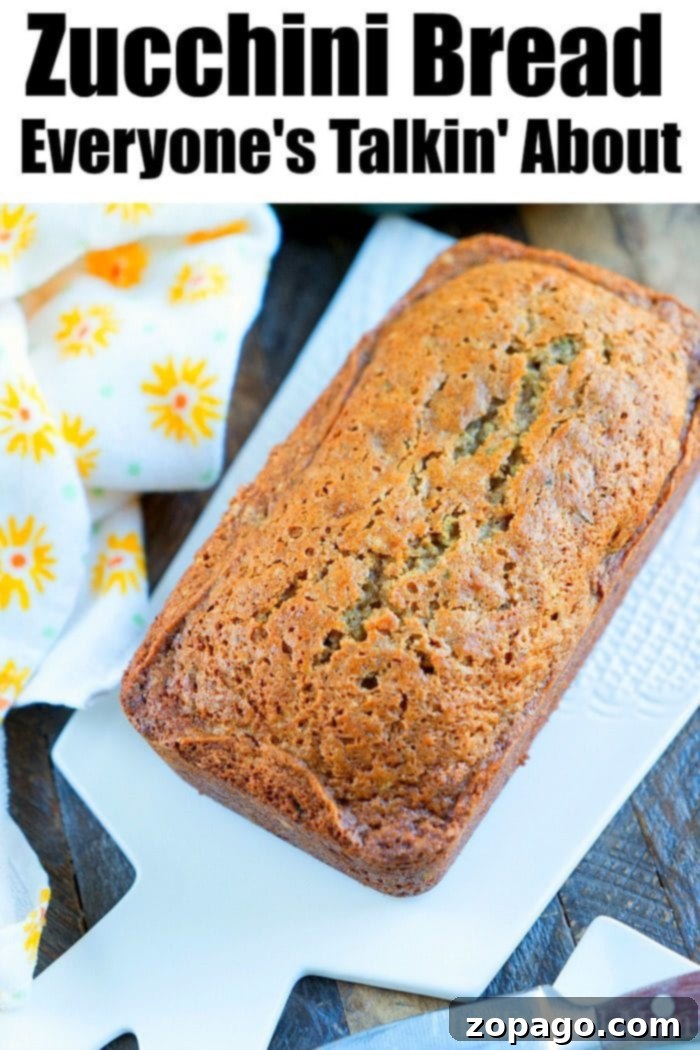 A freshly baked loaf of moist zucchini bread, showcasing its perfect golden crust and tender texture, ready to be enjoyed as a delightful sweet treat.