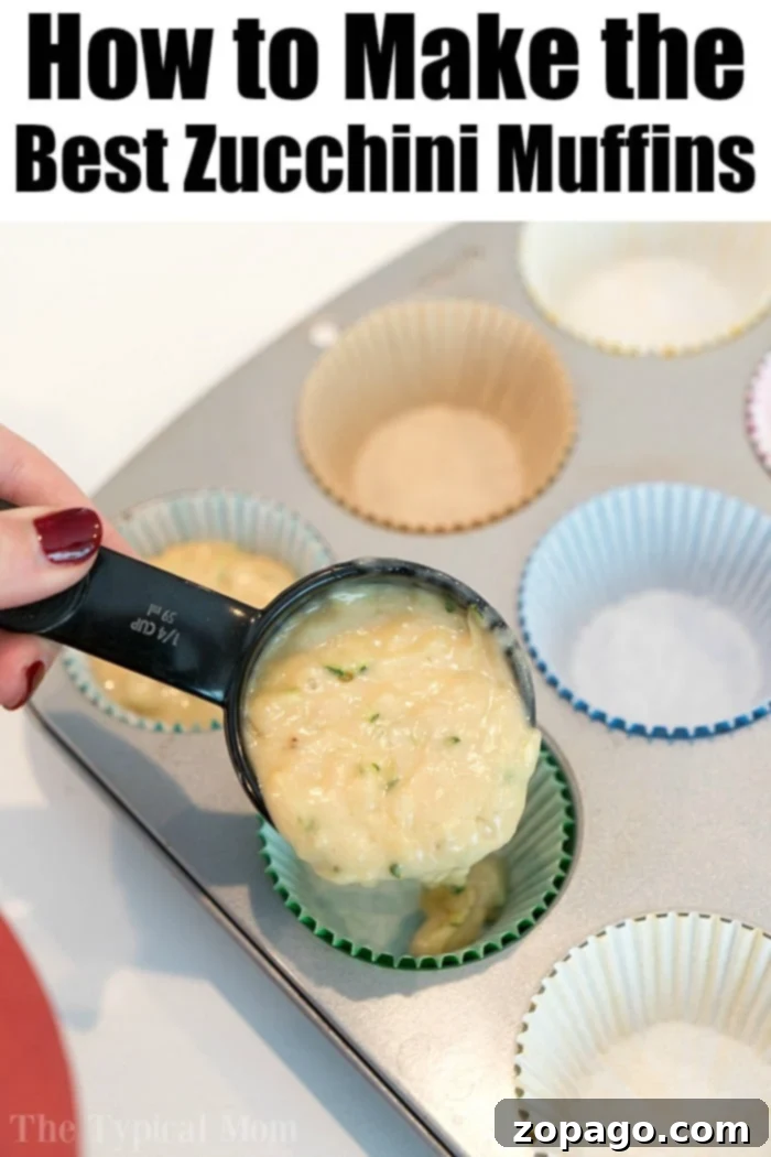 Scooping moist zucchini muffin batter into a muffin tin lined with paper cups, a perfect method for making individual servings of this delicious recipe.