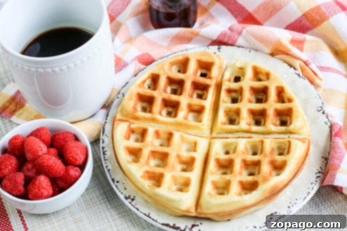 Festive Christmas Brunch Creations 6 A stack of perfectly golden homemade waffles, ready for a variety of sweet and savory toppings at a brunch bar.