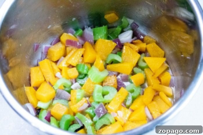 Easy Instant Pot Dressing 4 A close-up view of perfectly cooked Instant Pot stuffing in a round casserole dish, showing off its golden-brown top and moist, flavorful interior.