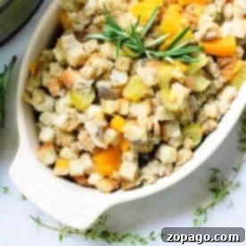 A white dish filled with delicious instant pot stuffing, topped with herbs and diced vegetables like celery and squash.