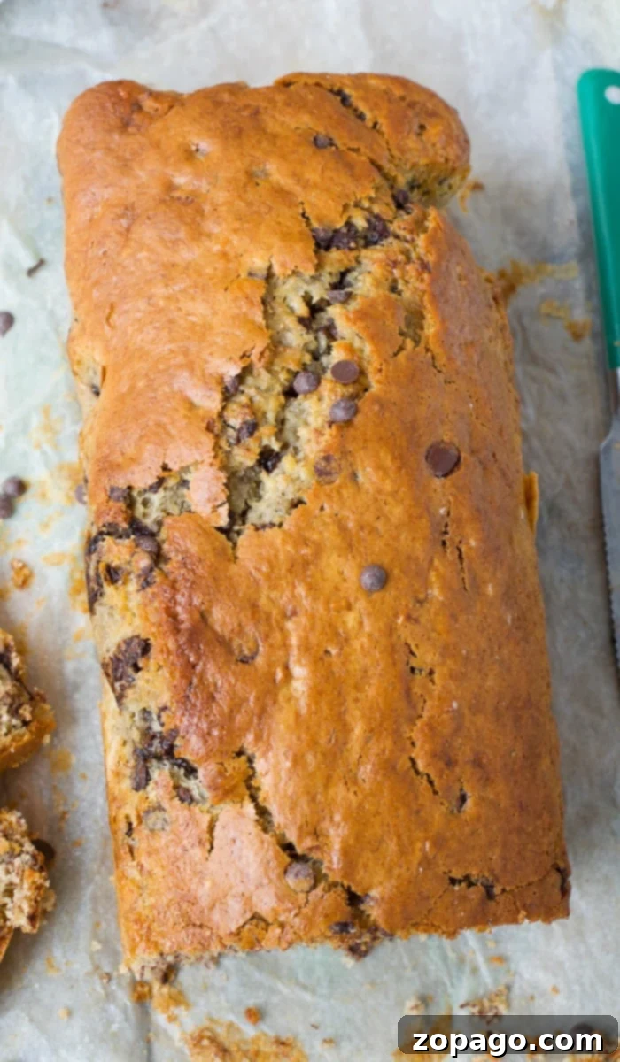 Easy 4-Ingredient Banana Bread 7 A sliced loaf of moist cake mix banana bread on a serving plate.