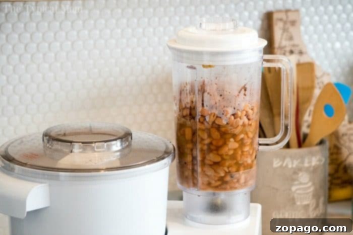 Homemade pressure cooker refried beans recipe that uses no lard and there is no pre soaking required! Perfect addition to burritos or 7 layer dip! #instantpot #refriedbeans #beans #pressurecooker #instantpotrecipes #thetypicalmom #homemade Healthy refried beans, featuring black beans as an alternative to pinto beans, offering a richer flavor.