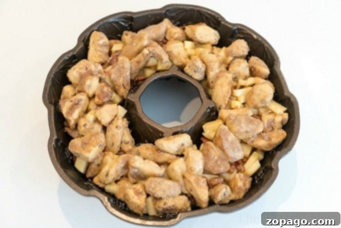 Caramel Apple Monkey Bread 4 Easy apple monkey bread, golden brown and ready to be flipped, in a bundt pan.
