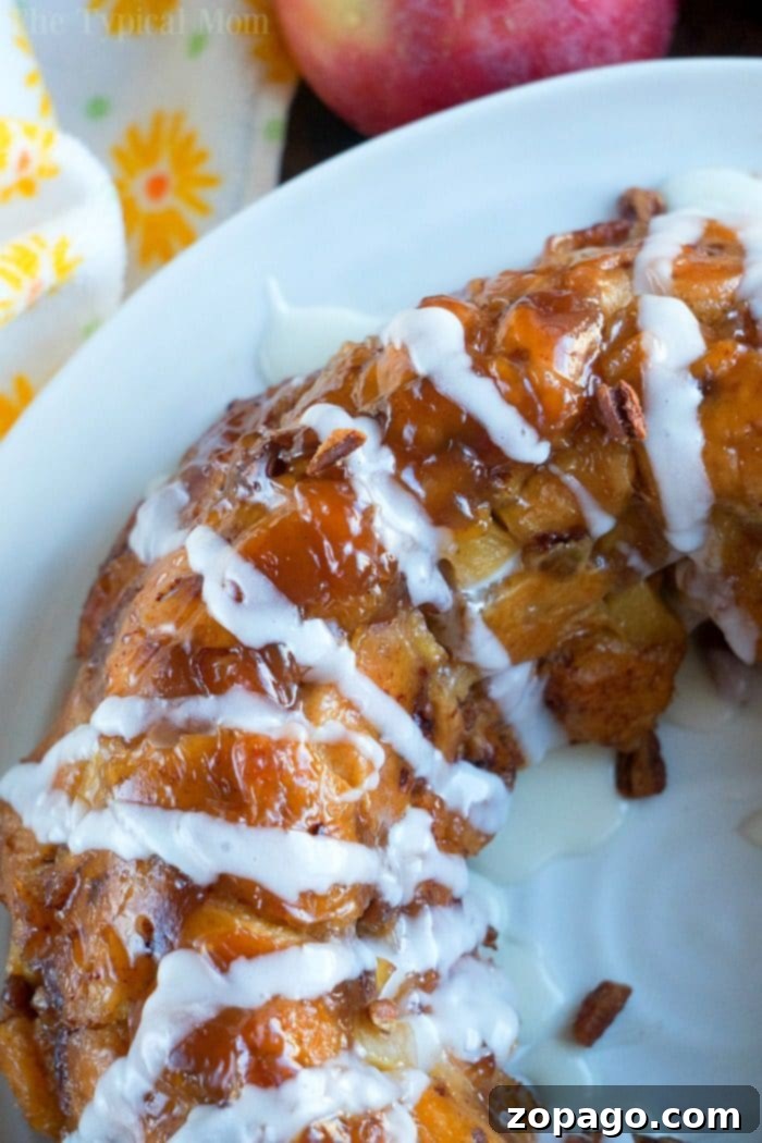 Caramel Apple Monkey Bread 7 Flipped apple monkey bread with vanilla icing drizzled over the top, ready to serve.