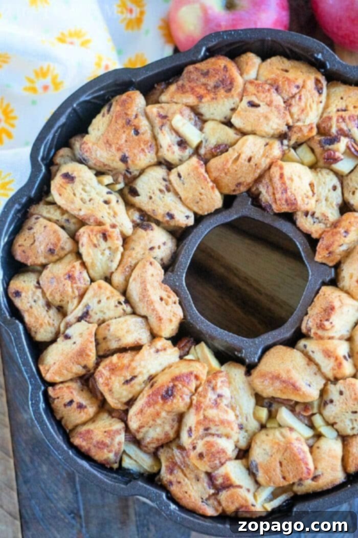 Caramel Apple Monkey Bread 9 Pillsbury apple cinnamon monkey bread, golden and glistening with glaze, in a bundt pan presentation.