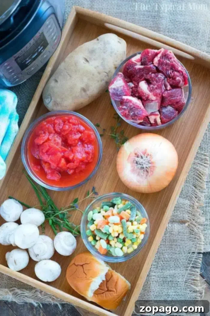 Essential Ingredients for a Delicious Pressure Cooker Beef Pot Pie Soup A wooden tray holds the makings of a hearty beef pot pie soup: a whole potato, raw beef chunks, diced tomatoes in a bowl, a whole onion, sliced mushrooms, mixed frozen vegetables, fresh thyme, and a bread roll. An electric pressure cooker is partially visible in the corner.
