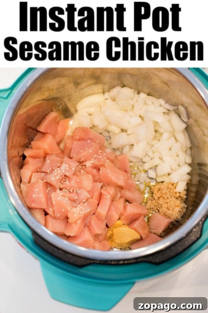Instant Pot sesame chicken, glazed and garnished with green onions and sesame seeds.