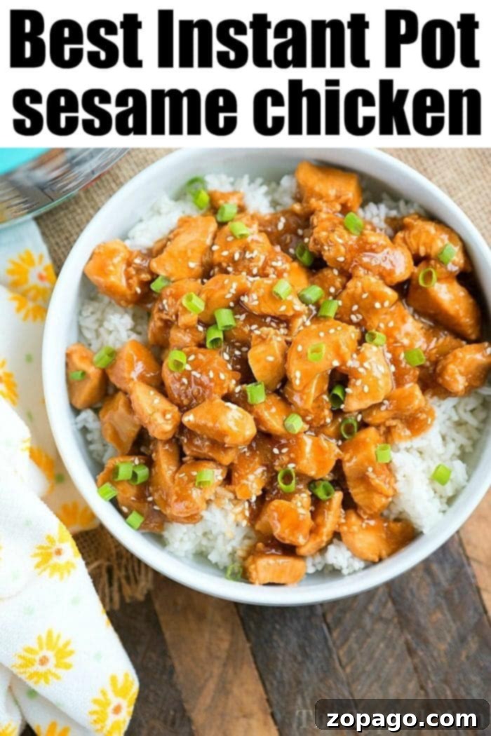 Pressure cooker sesame chicken, generously coated in sauce, garnished with green onions.