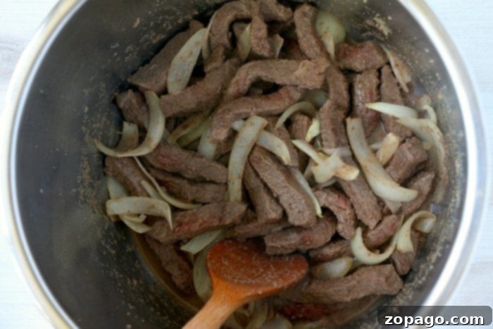 Tender beef being cooked in an Instant Pot