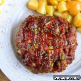 One-Pot Pressure Cooker Meatloaf and Potato Dinner 4 Pressure cooker meatloaf with herbs is elegantly glazed and served on a white plate, paired with perfectly roasted potato cubes.