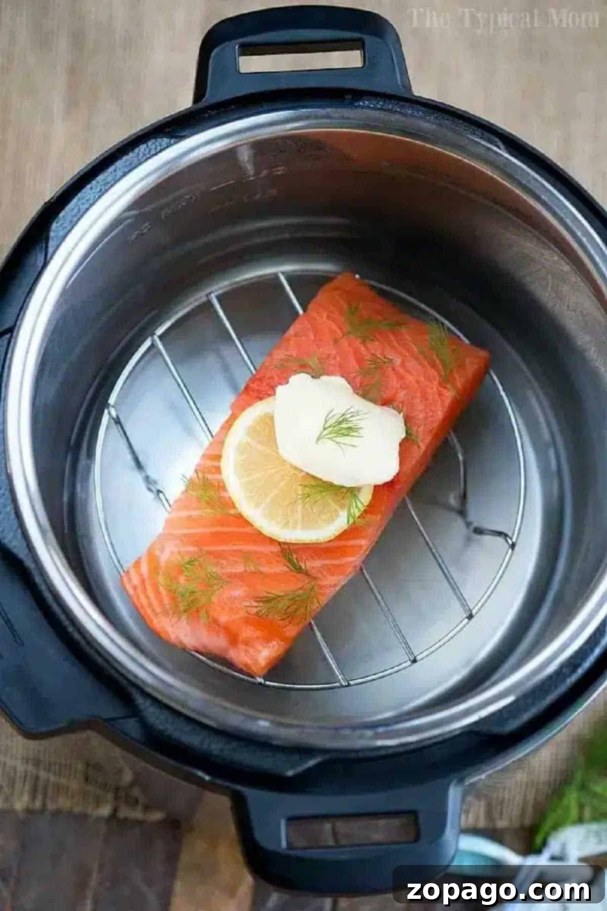 Quick & Healthy Pressure Cooker Salmon Recipe Perfectly cooked salmon fillet with lemon, butter, and dill, nestled on a metal rack inside a pressure cooker, ready for a healthy and quick dinner.