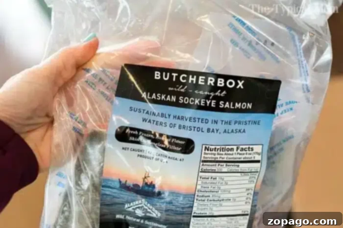 ButcherBox Alaskan Sockeye Salmon for Pressure Cooking A hand holding a package of ButcherBox wild-caught Alaskan sockeye salmon, highlighting sustainable harvesting details, perfect for pressure cooker recipes.