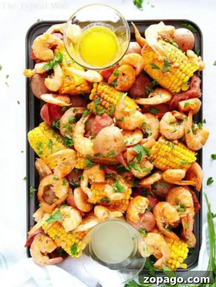 Delicious Instant Pot Shrimp Boil A vibrant Instant Pot shrimp boil with seasoned shrimp, corn on the cob, red potatoes, and sausage slices, garnished with fresh parsley and served with two dipping sauces.