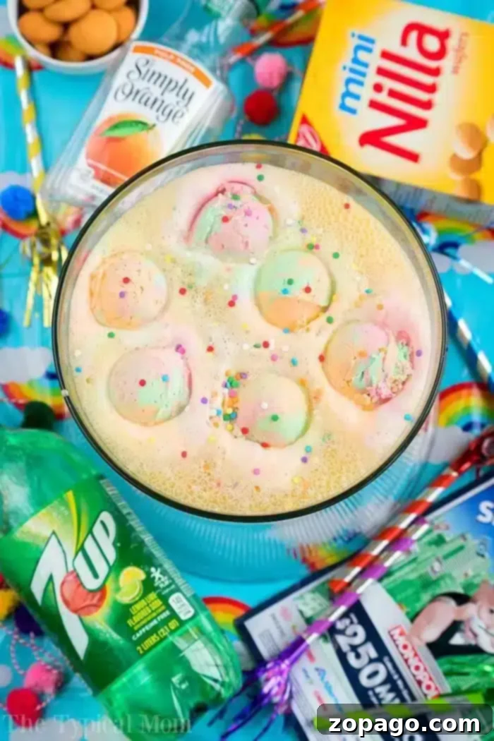 Discover the best 3-ingredient party punch recipe for your next birthday party, baby shower, or bridal shower. This sherbet punch with Sprite is easy, delicious, and guaranteed to be a hit! #partypunch #sherbetpunch #nonalcoholicdrink #birthdaypartyideas #babyshowerdrinks A vibrant bowl of colorful party punch, generously topped with scoops of rainbow sherbet and festive sprinkles, sits amidst an array of accompanying items. Cans of Simply Orange juice and 7Up sparkle nearby, alongside a box of Mini Nilla wafers and packets of Kool-Aid. Colorful straws and charming festive napkins complete this delightful setup, inviting guests to indulge in a joyful celebration. This image perfectly captures the essence of a simple yet spectacular party punch that delights both kids and adults.