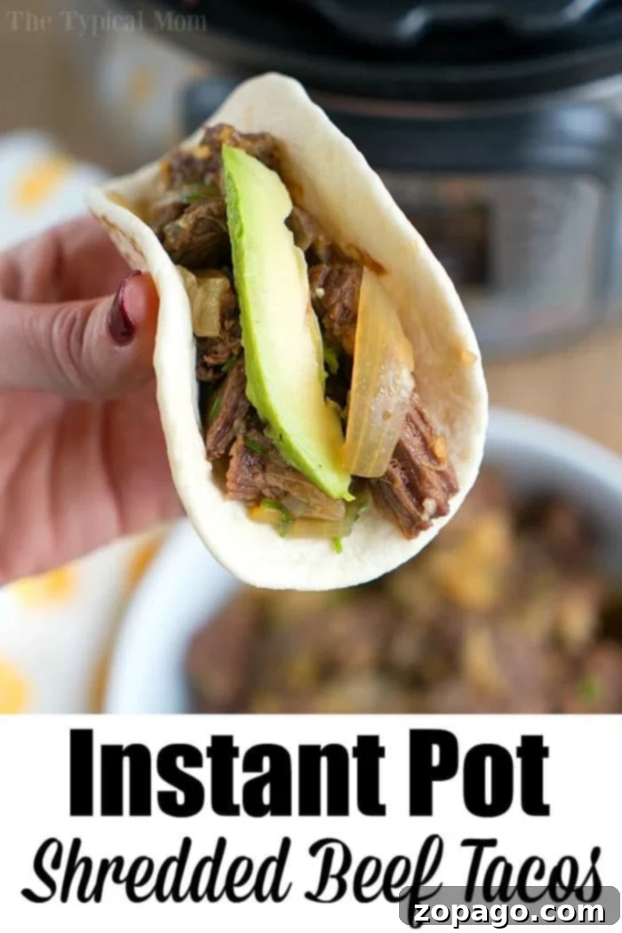 French onion pressure cooker roast is tender with tons of flavor. Perfect Instant Pot shredded beef tacos for dinner even your kids will rave about. A hand holds a shredded beef taco, its flavor elevated by tender, pressure-cooked blade roast, with creamy avocado and onions nestled in a soft shell.