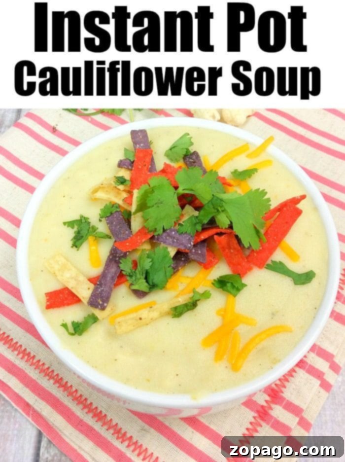 Instant Pot cauliflower soup is a creamy and delicious low carb meal our whole family loves! Easy to throw together keto soup you'll make again and again. Creamy Pressure Cooker Cauliflower Soup with green garnish