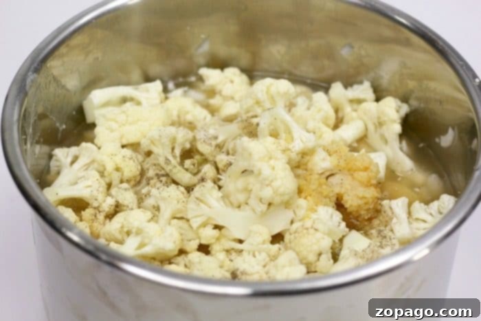 Instant Pot cauliflower soup is a creamy and delicious low carb meal our whole family loves! Easy to throw together keto soup you'll make again and again. Easy cauliflower soup ingredients in a bowl