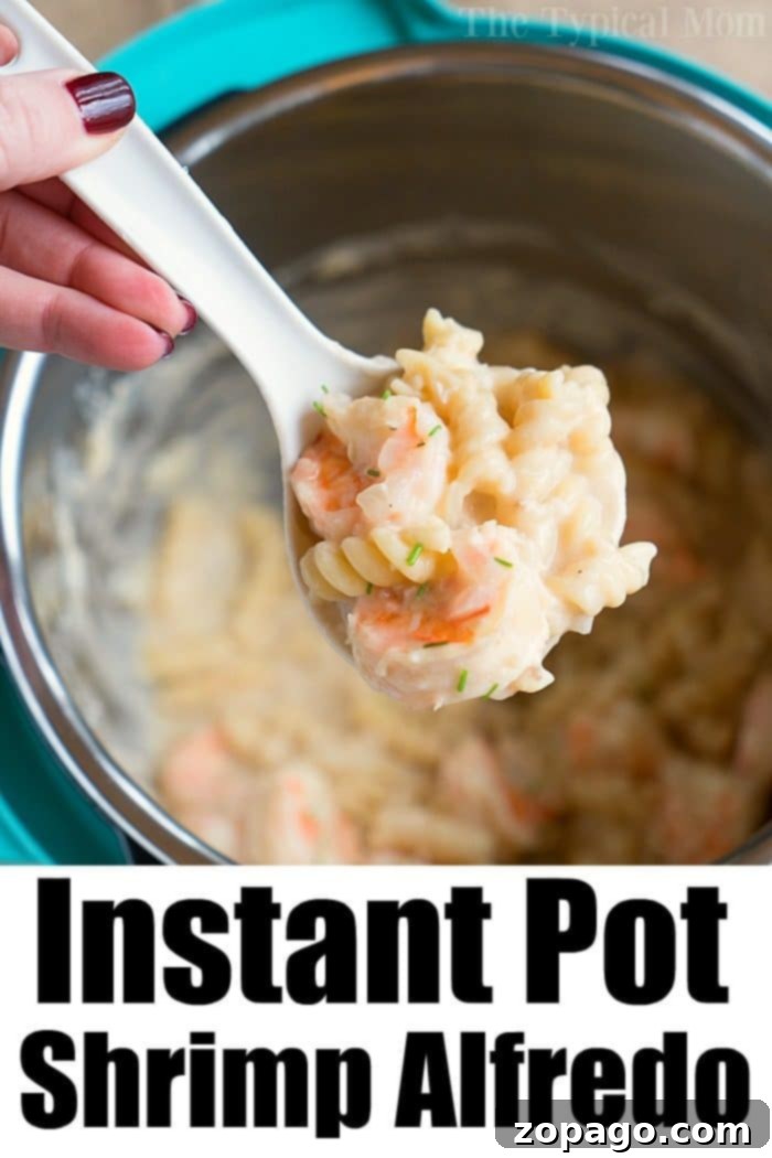 Close-up of Instant Pot Shrimp Alfredo pasta in a serving bowl, garnished with fresh herbs and grated cheese