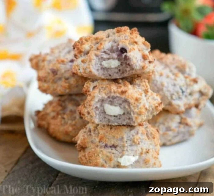 Crispy Air Fryer Bagel Bites 2 A plate of stacked Bagel Bites Air Fryer treats filled with cream cheese sits on a wooden table.
