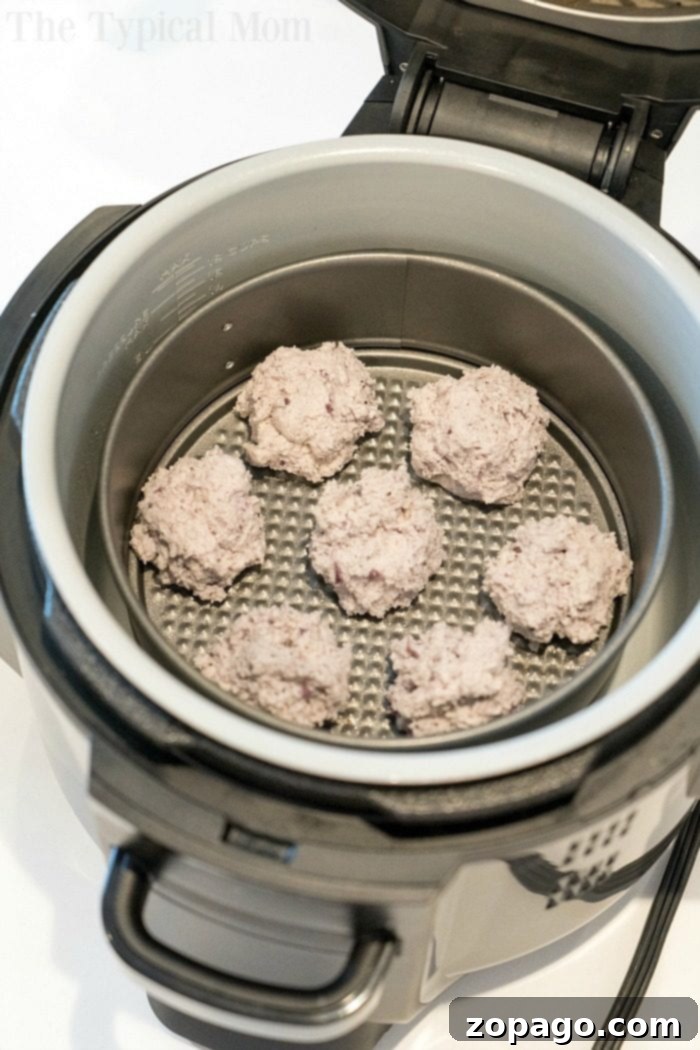 Crispy Air Fryer Bagel Bites 8 bagel bites inside an ninja foodi on a metal rack pair perfectly with 2 Ingredient Air Fryer Bagel Bites for a quick and delicious meal.