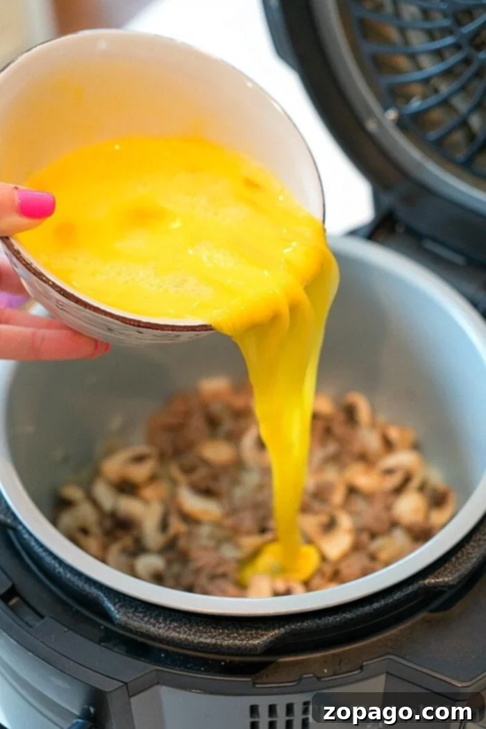 Ninja Foodi Breakfast Omelette: Your new go-to air fryer recipe for a quick and easy breakfast, packed with eggs, cheese, and your favorite meat. A piping hot air fryer omelette, golden and fluffy, freshly cooked in a Ninja Foodi pot. The edges show a slight crispness, promising a delicious bite.