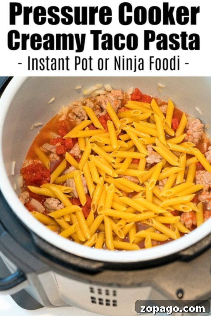Pressure cooker taco pasta: creamy, cheesy noodles with sausage and tomatoes – a true comfort food for all ages. Delicious pressure cooker taco pasta, a hearty and satisfying meal.