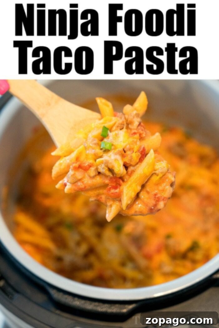 Ninja Foodi taco casserole: creamy, cheesy, and packed with savory sausage and tomatoes. A bowl of hot and fresh Ninja Foodi Taco Pasta, garnished with fresh cilantro, ready to be enjoyed.