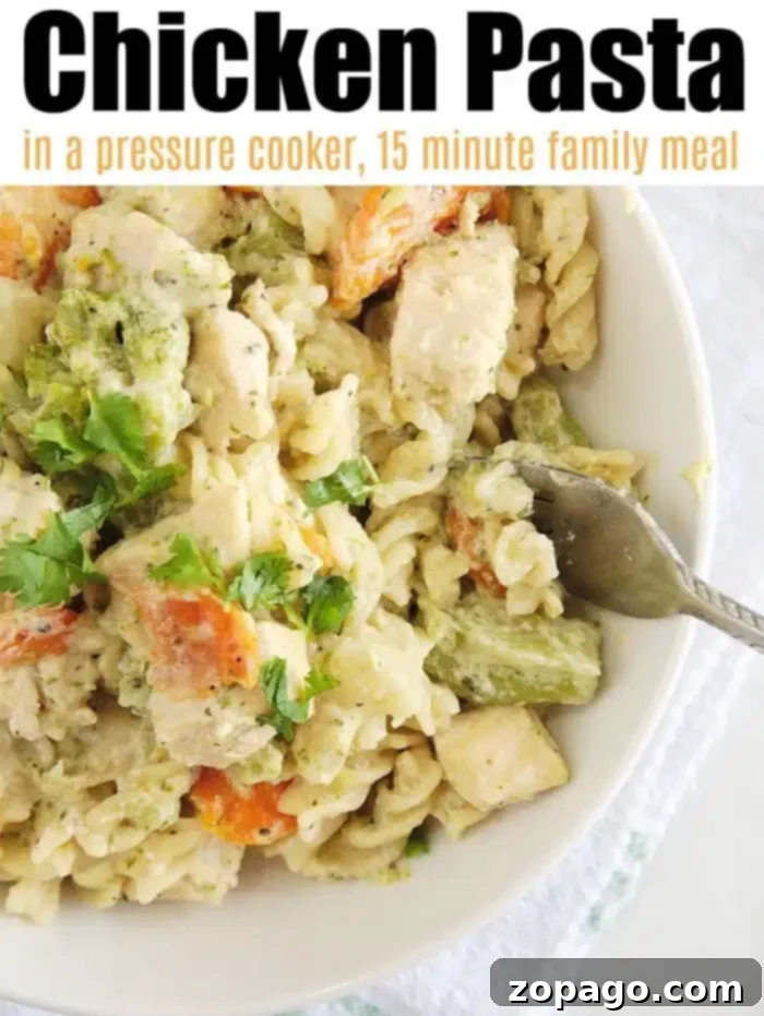 A bowl of creamy Instant Pot chicken pasta with tender chicken, broccoli, and carrots, garnished with fresh herbs. The dish is presented as a delicious, quick, and easy family meal.
