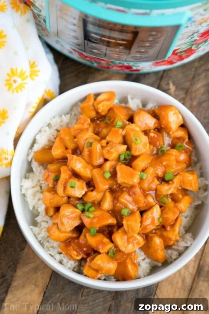 Tropical Instant Pot Chicken 7 Close-up of a serving of Instant Pot Hawaiian chicken with rice, garnished with green onions